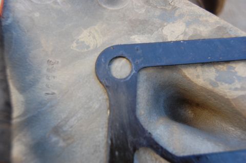 1994 Ford Bronco - A close-up view shows stamped numbers "3831" on a gray metal surface, partially obscured by a dark blue gasket with a circular cutout.