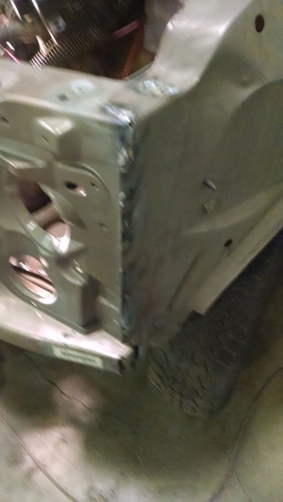 Close-up of welded metal body panels on a vehicle in a workshop.