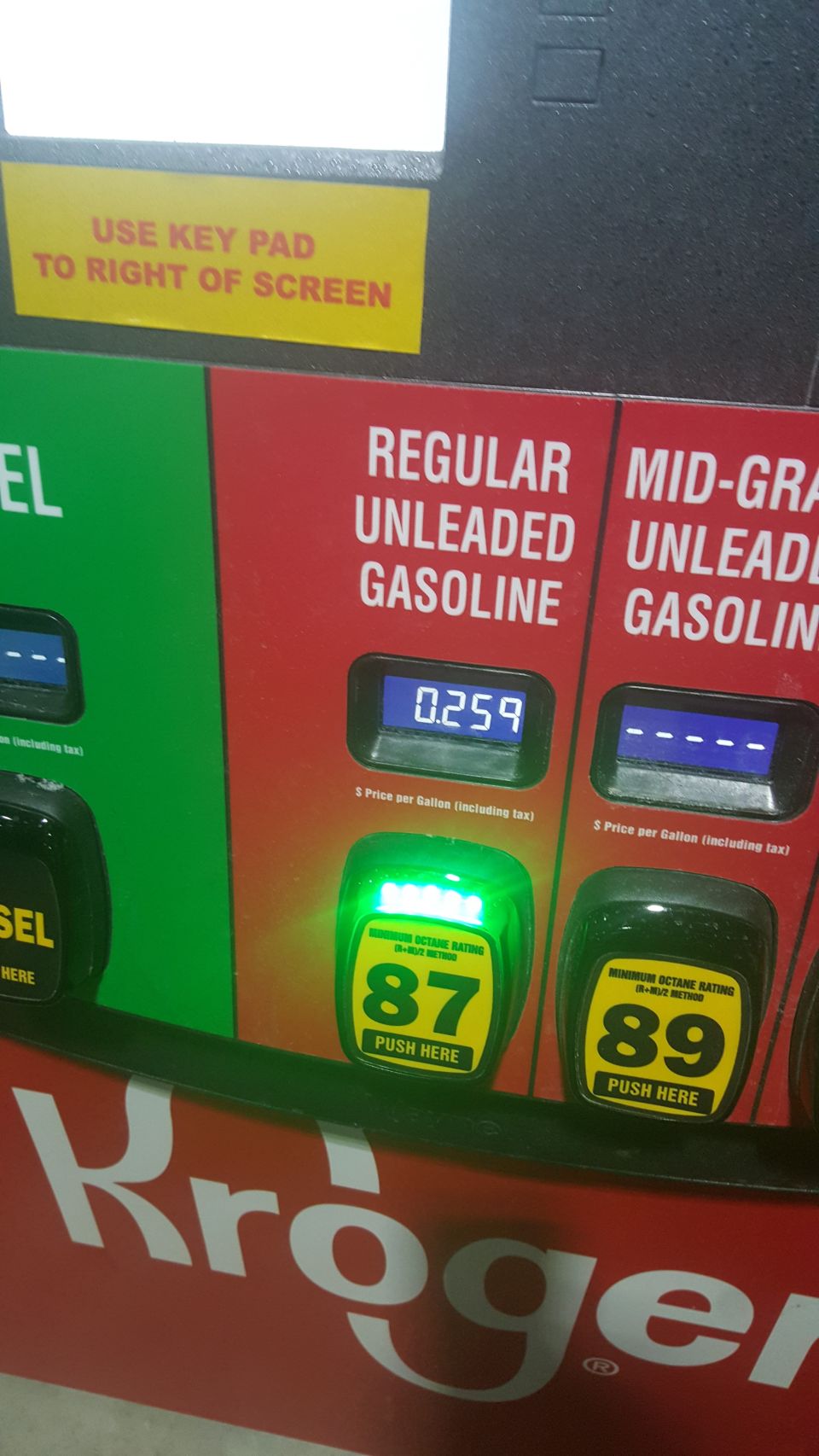 Gas pump at a Kroger station showing fuel prices.