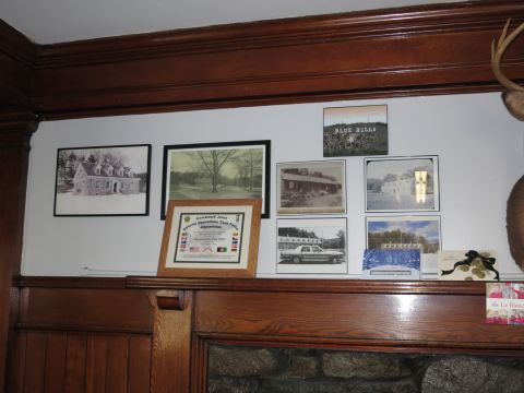 1991 Ford LTD Crown Victoria - Photo of a paneled wall display of framed photos and a plaque, not a technical document.