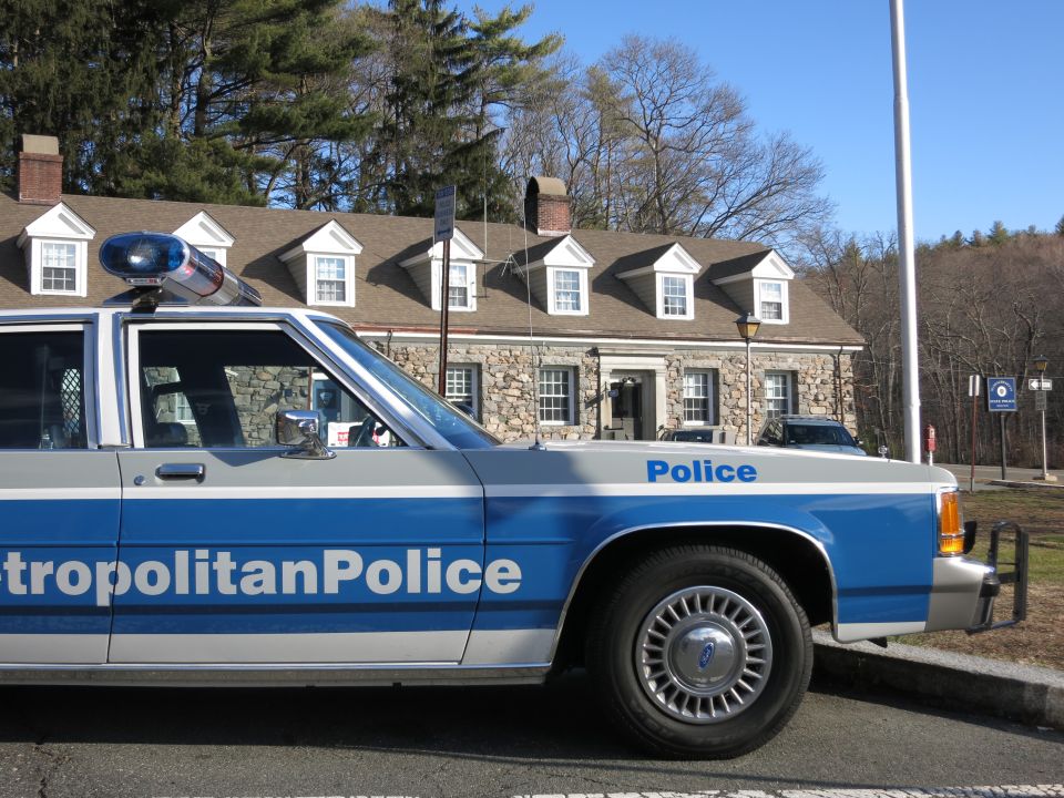 Close side view of Metropolitan Police Crown Victoria with stone building behind