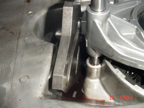 1987 Ford Bronco - A detailed view of a transmission part, showing mechanical components and fluid.