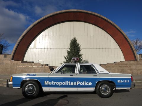 1991 Ford LTD Crown Victoria - Photo of a Metropolitan Police Crown Victoria parked before an arched amphitheater shell.