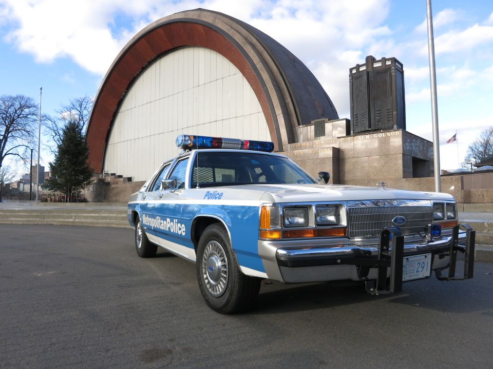 Front view of a blue and white Metropolitan Police Crown Victoria with push bar