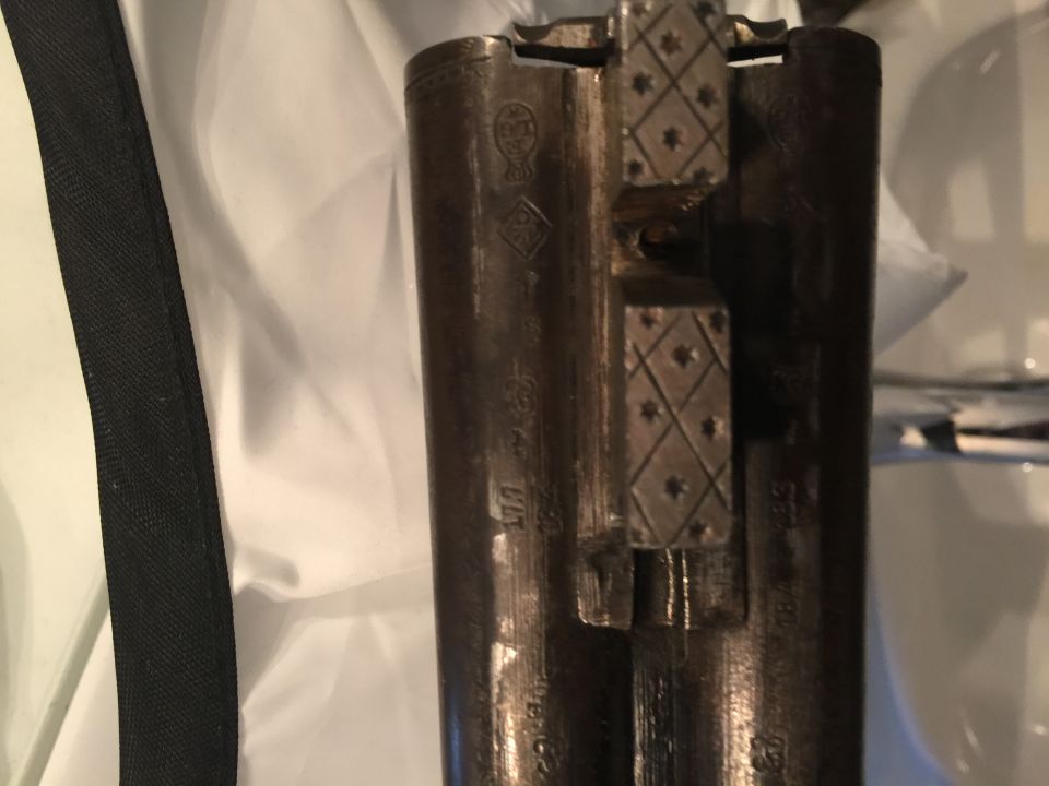 Close-up of engraved shotgun receiver and barrels