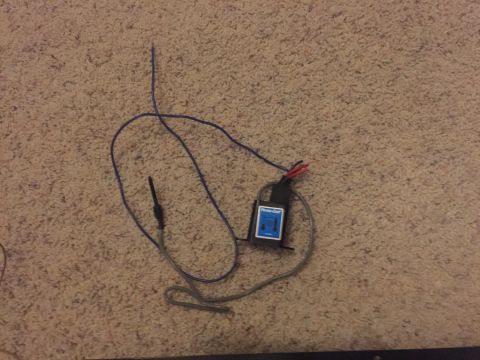 1982 Ford Bronco - A black electronic module with a blue label that says "Perma-Cool" is shown on a carpeted surface. It has wires connected to it, including…