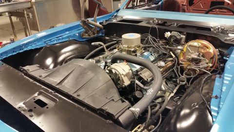 2015 Chevrolet new - The engine bay of a classic blue car is shown, featuring a V8 engine with a carburetor, alternator, and brake booster assembly. The vehicle…