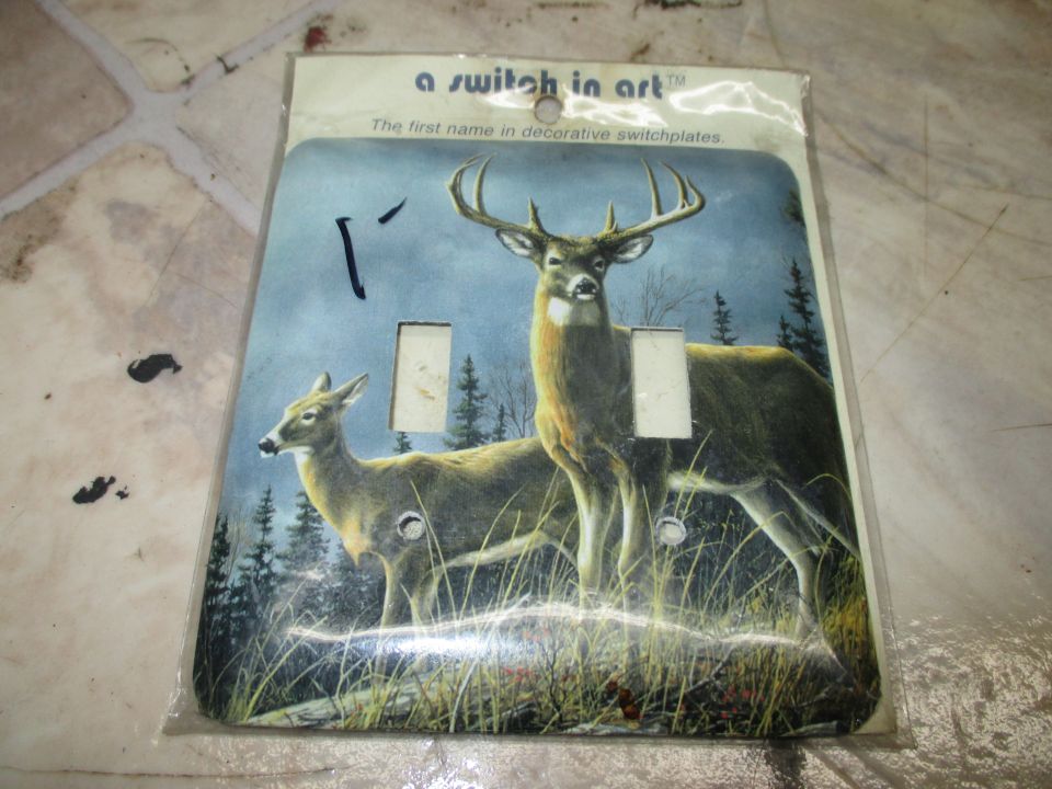 Photo of a decorative deer switchplate in packaging