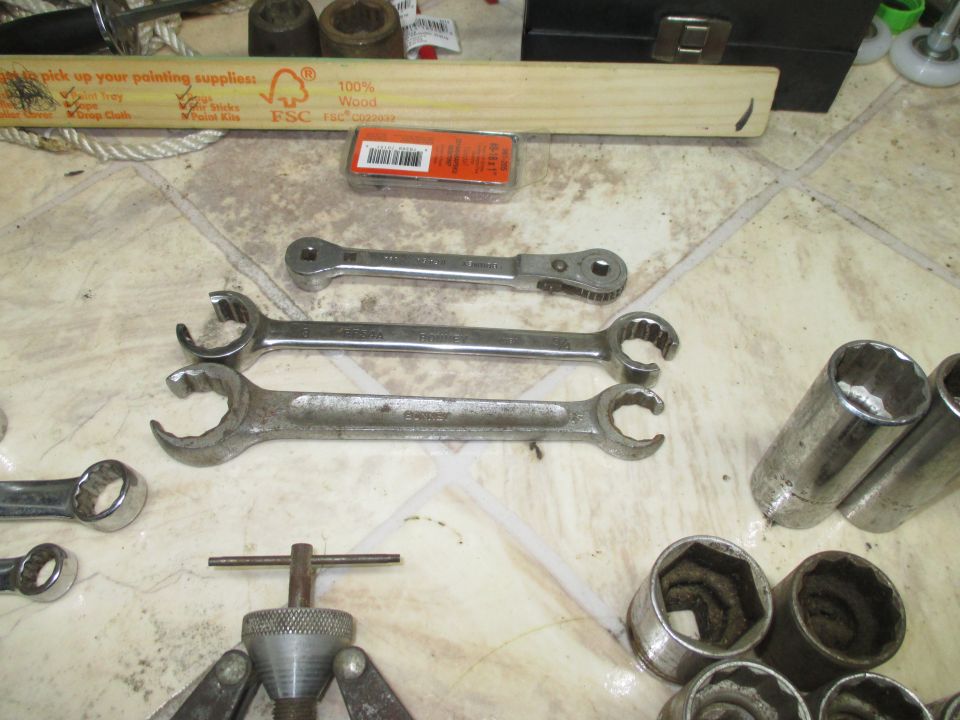Flare-nut and ratcheting wrenches on a workbench