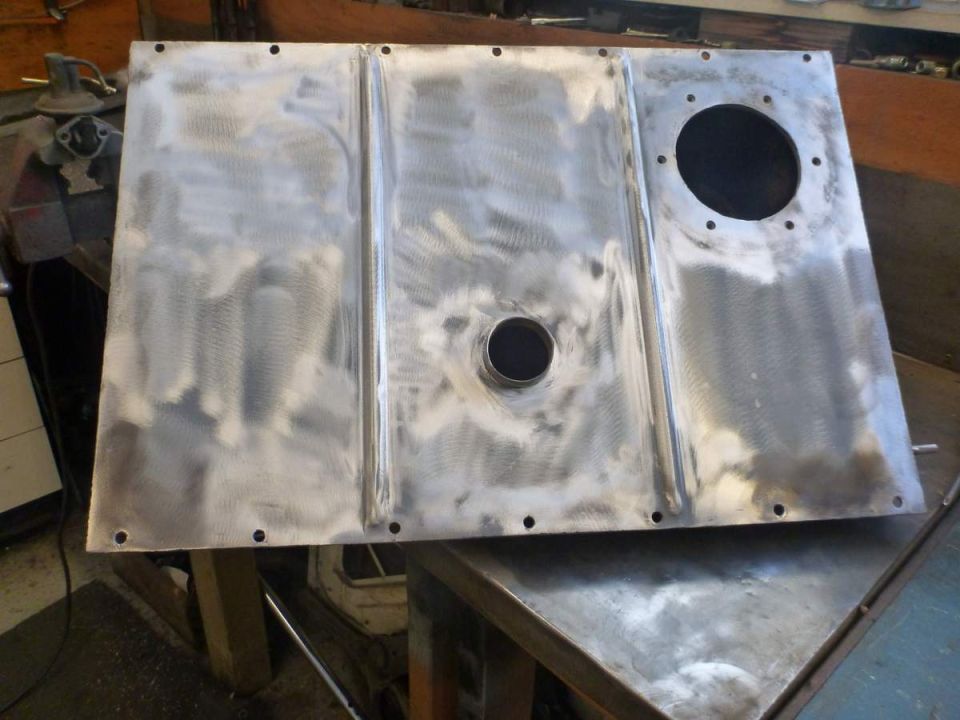 Bare metal vehicle panel with holes and ribs