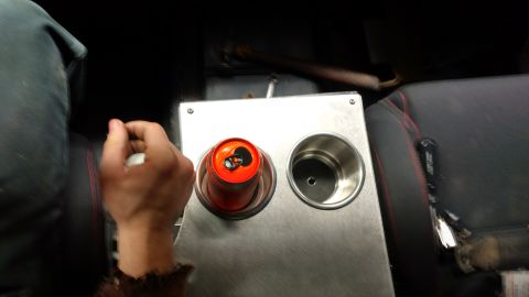 1967 Ford F-250 - Interior view of a vehicle's center console with a can in one of the cup holders.