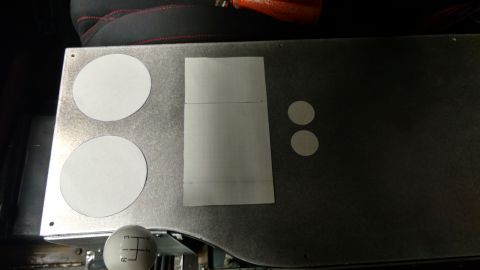 1967 Ford F-250 - Close-up of a vehicle's interior, a metal panel with cutouts and a template, alongside a shift knob.