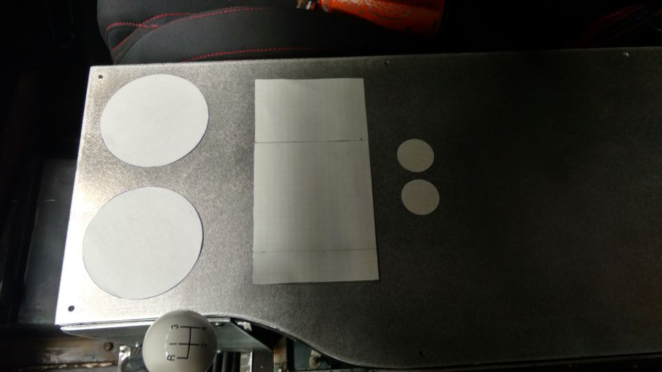 Vehicle interior with metal panel, template, and shift knob showing gear pattern