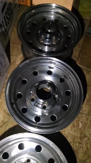 1994 Ford Bronco - Two aluminum wheels are shown stacked. A box labeled "CLASSIC" is visible in the background.