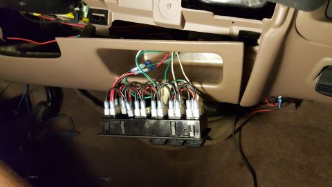 1996 Ford Bronco - Aftermarket switch panel wiring installed in a vehicle's dashboard area.
