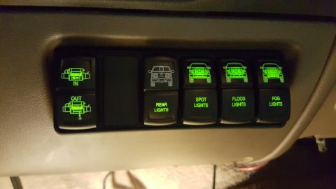 1996 Ford Bronco - Custom switch panel with illuminated icons and labels for various vehicle lighting and accessory functions.