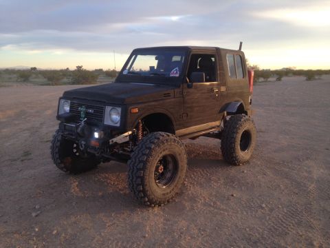 1987 Suzuki Samurai - This Suzuki Samurai is modified with large off-road tires and a lifted suspension, ready for rough terrain.
