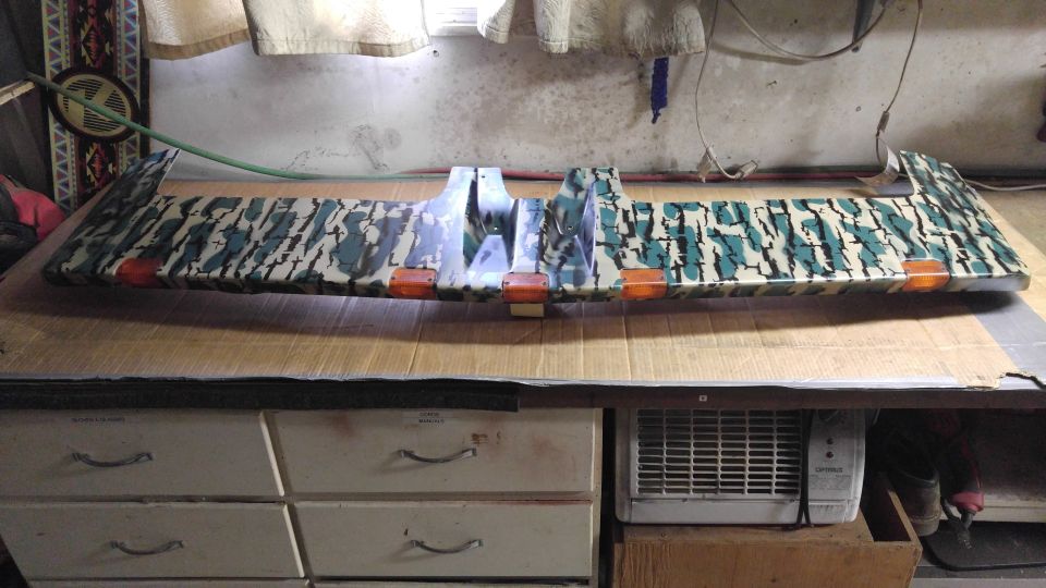 Camouflaged truck sun visor with orange marker lights