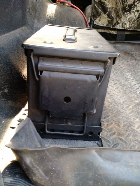 1992 Ford Bronco - An ammo can is visible in the cargo area of a vehicle, with a red wire attached.