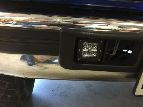 1996 Ford Bronco - A close-up view of the front bumper on a 1992 Ford Bronco, showing an installed aftermarket LED fog light.