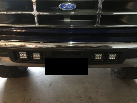 1996 Ford Bronco - Front view of a Ford truck, showing the grille and bumper with newly installed LED fog lights.
