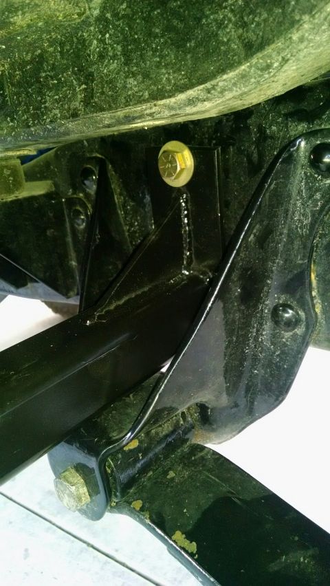 1979 Ford Bronco - This photo shows a close-up view of a vehicle's frame and a slider bracket, with visible bolts and mounting hardware.