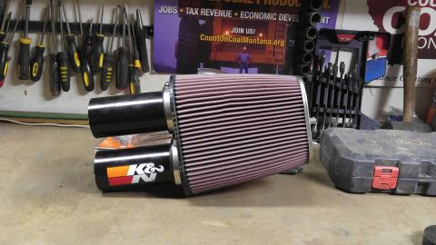1991 Ford Bronco - A K&N air filter assembly with dual intake tubes is shown on a workbench.