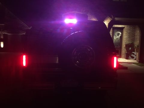 1996 Ford Bronco - Rear view of a 1996 Ford Bronco at night with its lights on.