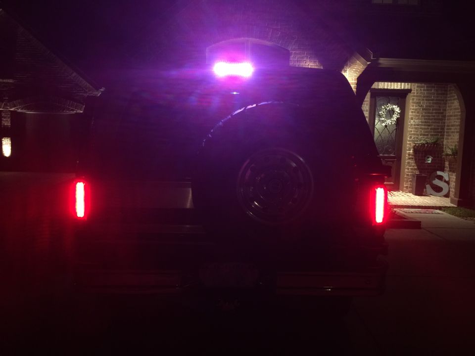 1996 Ford Bronco rear view at night, showing tail lights and third brake light illuminated