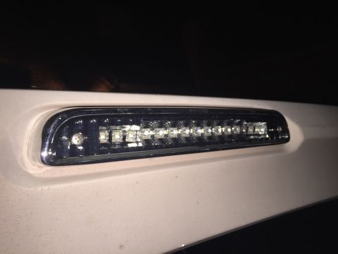 1996 Ford Bronco - Close-up of a vehicle's third brake light assembly, showing LED illumination.