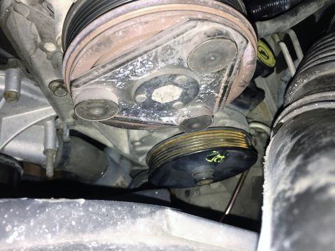 1996 Ford Bronco - Close-up view of an engine's pulley system, highlighting the mechanical components and their condition.