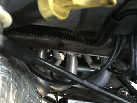 1996 Ford Bronco - A view of the engine's exhaust manifold and associated wiring and tubing.