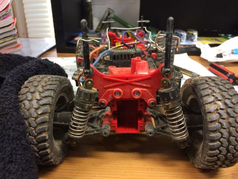 1989 Ford Bronco - The rear suspension and chassis of a remote control car are shown, with visible wiring and electronic components.