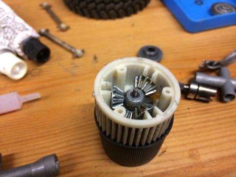 1989 Ford Bronco - A close-up view of a disassembled differential gear assembly, showing the internal gears and housing.