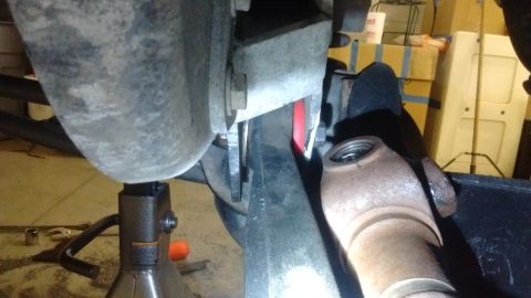1985 Ford Bronco - Undercarriage view of vehicle suspension components, possibly during maintenance or repair.