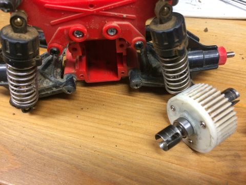 1989 Ford Bronco - Close-up of a disassembled remote control car chassis and its differential.