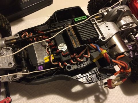 1989 Ford Bronco - Close-up of the internal components of an RC car chassis, including servos and motor.
