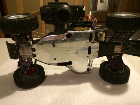 1989 Ford Bronco - Underside view of a radio-controlled car chassis with visible suspension and tires.