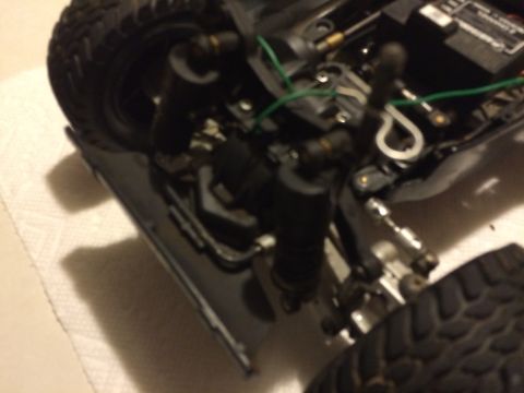 1989 Ford Bronco - Detail shot of the suspension and tire assembly on a model vehicle, likely an RC car.