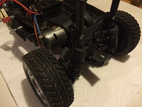 1989 Ford Bronco - Close-up of an RC car chassis, focusing on the motor and suspension components.