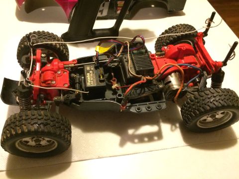1989 Ford Bronco - The chassis of a remote-controlled car is shown with its internal components and suspension system exposed.
