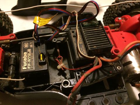 1989 Ford Bronco - A close-up view of the internal electronics of an RC car, including the Futaba receiver and speed controller.