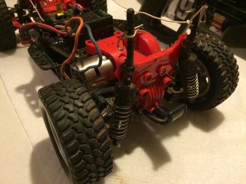 1989 Ford Bronco - The rear suspension and drivetrain of a remote-controlled off-road vehicle are shown in a close-up, angled shot. Visible components include…