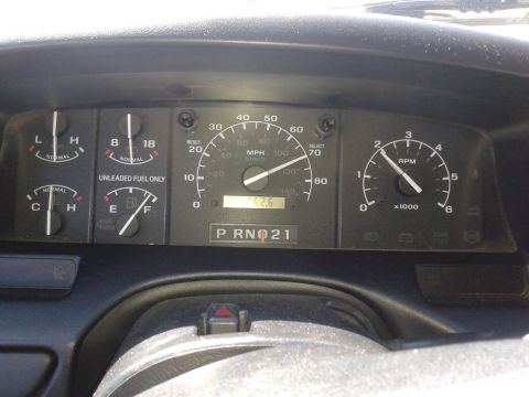 1996 Ford Bronco - The image shows the interior dashboard of a 1996 Ford Bronco, focusing on the instrument cluster. Visible gauges include the speedometer, t…