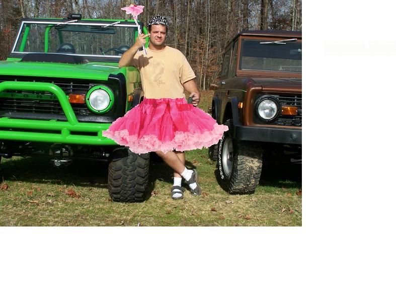 Man in tutu and tiara between green and brown Ford Broncos