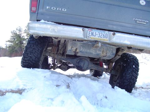 1979 Ford Bronco - Ford Expedition navigates a snowy terrain, highlighting its robust off-road capabilities and rear suspension system.