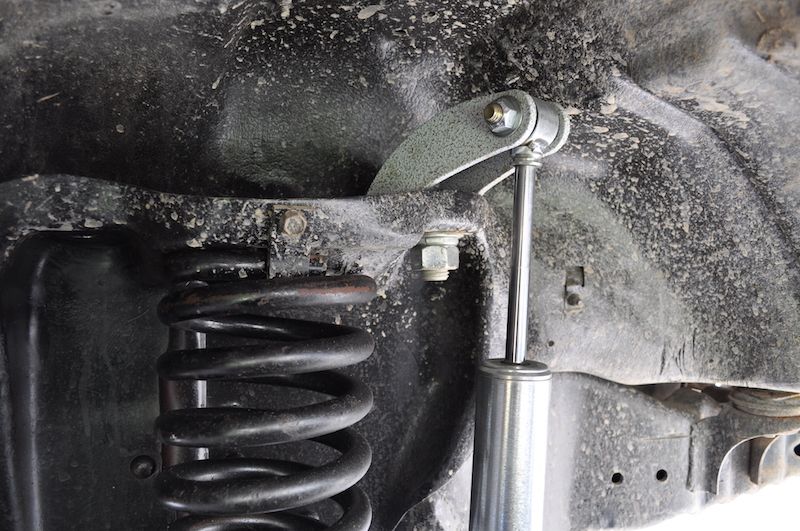 1981 Ford Bronco suspension with coil spring and modified shock mount.