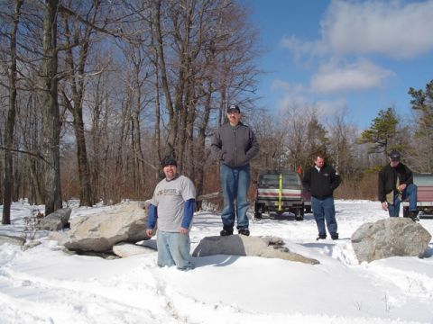 1979 Ford Bronco - Men pose with trucks in a snowy, wooded area under a bright blue sky.