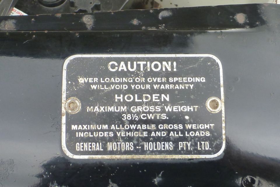 Caution plate for Holden vehicle with gross weight limits and warranty information.