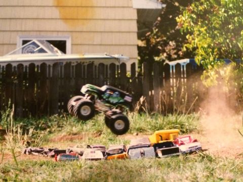 1989 Ford Bronco - RC monster truck mid-air jump, captured in motion.
